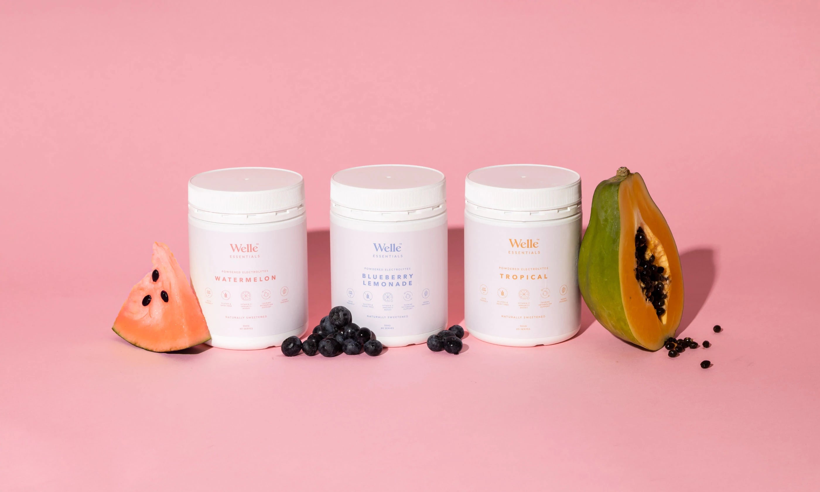 Electrolytes product range on pink background with fruit